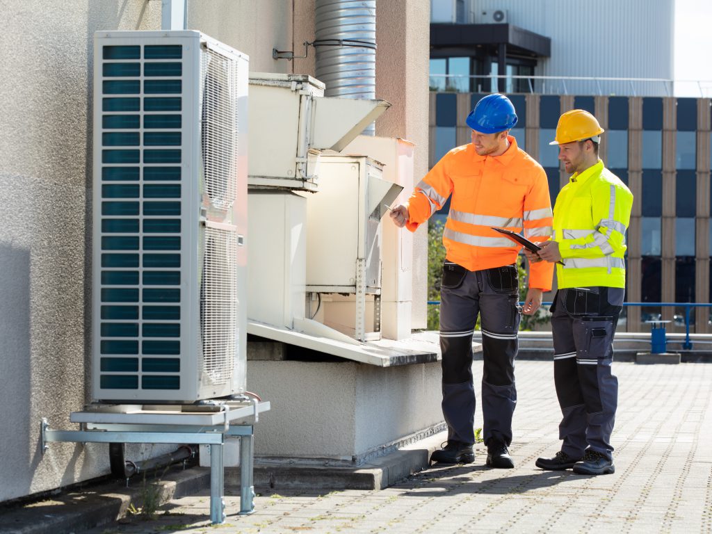 Photo of contractors examining an industrial HVAC system in Montana