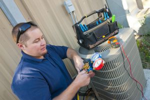 Photo of HVAC technician with ac outdoor unit